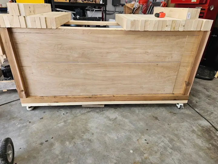 Unfinished wooden cabinet on casters