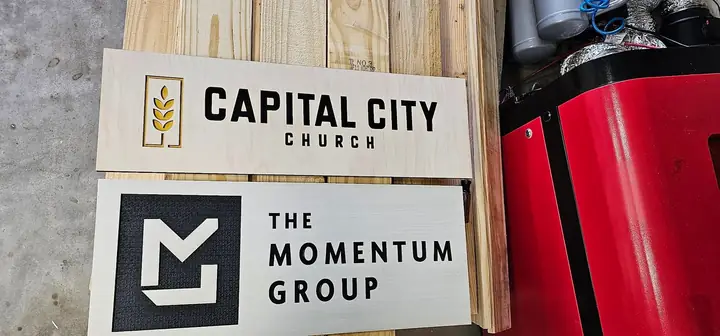 Stacked wooden signs for Capital City Church