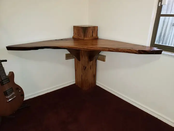 Live-edge wooden corner shelf with a small wooden box