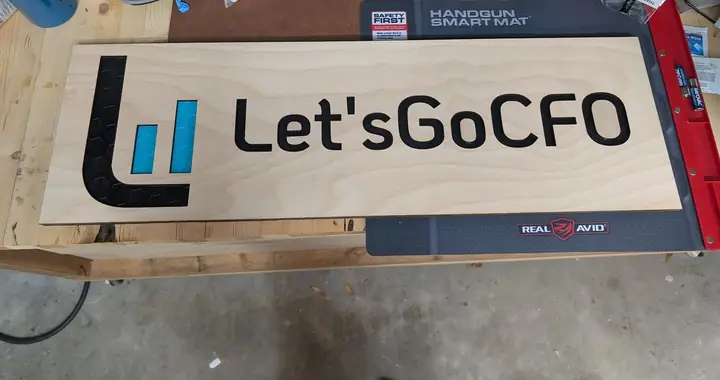 Wooden sign reading Let's Go CFO