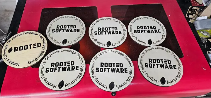 Round wooden pieces engraved Rooted Software