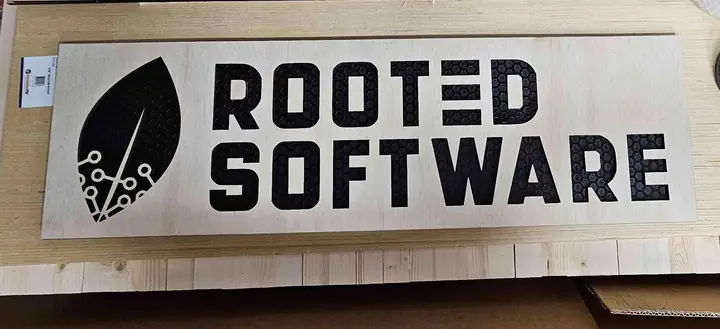 Long wooden sign reading Rooted Software