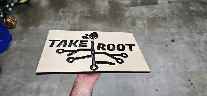 Wooden sign reading Take Root