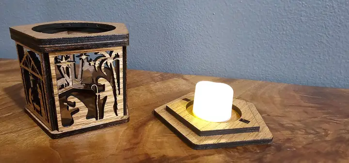 Wooden lantern beside a lit tea light
